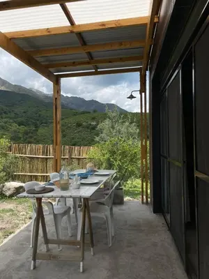 a table and chairs on a patio with a view at 