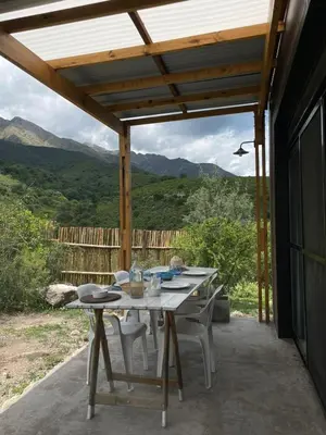 a table and chairs on a patio with a view at 