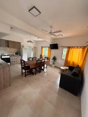 a kitchen and living room with a table and chairs at Complejo playa de oro 3 in Villa Carlos Paz