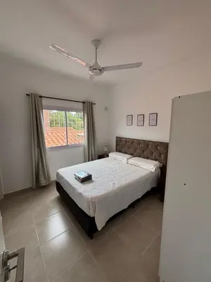 a bedroom with a bed and a ceiling fan at Complejo playa de oro 3 in Villa Carlos Paz