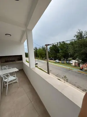 a balcony with a table and a view of a street at Complejo playa de oro 3 in Villa Carlos Paz