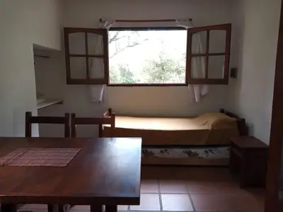 a small room with a table and a window at Cabañas Aaron in Villa de Las Rosas