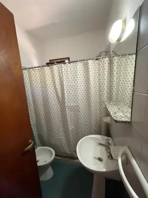 a bathroom with a sink and a toilet and a mirror at Cabañas Aaron in Villa de Las Rosas