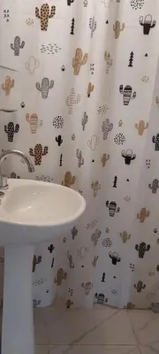 a bathroom with a sink and a shower curtain with bugs at CASA - HAUS - Villa Cura Brochero in Villa Cura Brochero