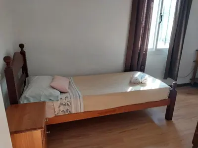 a small bed with a wooden frame in a room at Big House in Merlo