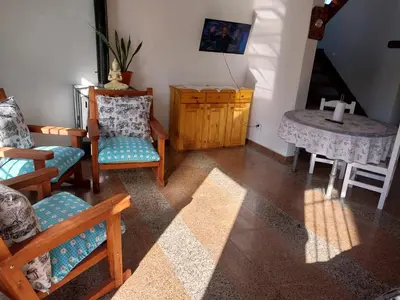 a room with chairs and a table with a cross on it at Big House in Merlo