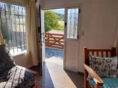 a room with a door open to a balcony with a view at Big House in Merlo