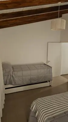a bedroom with a bed in a white wall at Casa Montana in Potrero de Garay