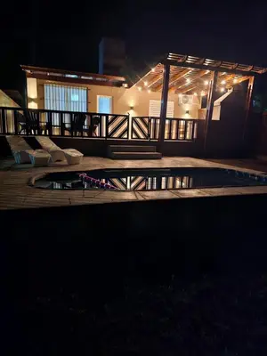 a night view of a house with a swimming pool at Casa Montana in Potrero de Garay