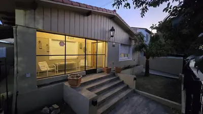 a house with a staircase in front of a window at La Casa De Los Recuerdos in Villa Carlos Paz