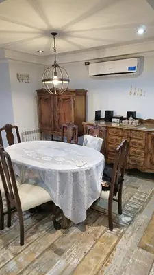 a dining room with a table and some chairs at La Casa De Los Recuerdos in Villa Carlos Paz