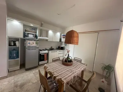 a kitchen with a table and chairs and a kitchen with a table and a table at Casa en Tanti con pileta in Tanti