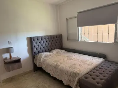 a bedroom with a bed and a window at Casa en Tanti con pileta in Tanti