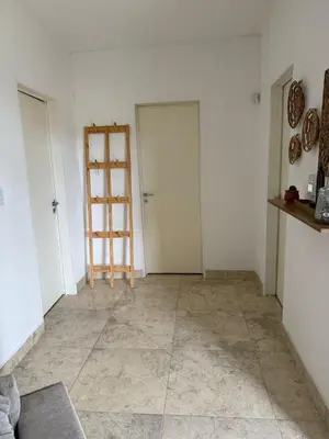 a room with two doors and a tiled floor at Casa en Tanti con pileta in Tanti