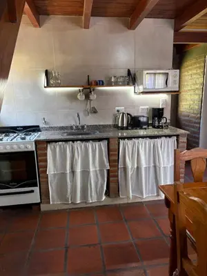 a kitchen with a sink and a stove at Sierra Dulce in Mina Clavero