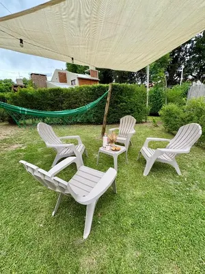 three chairs and a table under a tent at Sierra Dulce in Mina Clavero