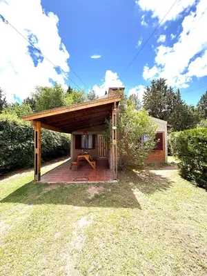 a small shelter in a yard with a building at Sierra Dulce in Mina Clavero