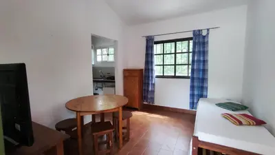 a living room with a table and a kitchen at Don Juan M Cabañas in Villa de Las Rosas