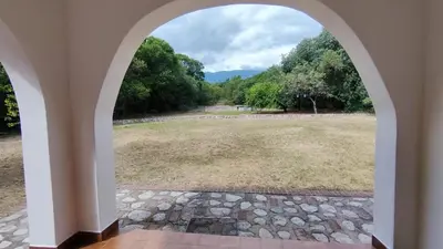 a view of a field through an archway at Don Juan M Cabañas in Villa de Las Rosas