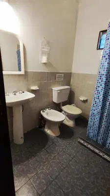 a bathroom with two toilets and a sink and a mirror at Don Juan M Cabañas in Villa de Las Rosas