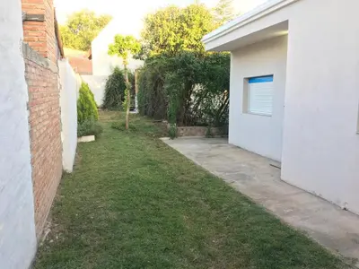 an empty yard next to a white house at Los Tilos in Mina Clavero