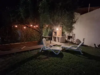 two lawn chairs sitting in the grass at night at Los Tilos in Mina Clavero
