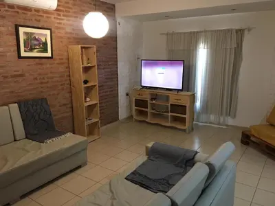 a living room with a couch and a flat screen tv at Los Tilos in Mina Clavero
