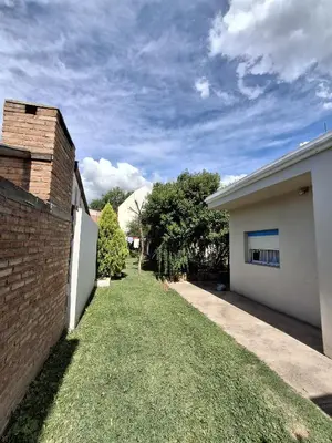 a backyard of a house with a grass yard at Los Tilos in Mina Clavero
