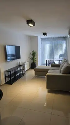 a living room with a couch and a flat screen tv at COFICO DPTO de CATEGORIA in Cordoba