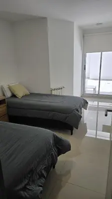 a bedroom with two beds and a window at COFICO DPTO de CATEGORIA in Cordoba