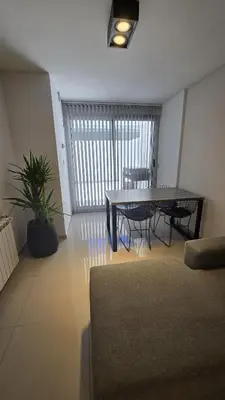 a living room with a table and a plant at COFICO DPTO de CATEGORIA in Cordoba