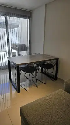 a dining table and chairs in a room with a window at COFICO DPTO de CATEGORIA in Cordoba