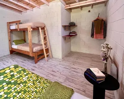 a small room with a bunk bed and a table at La Donosita in La Carolina in La Carolina