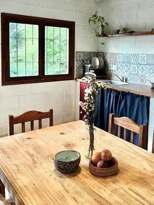 a kitchen with a wooden table with a bowl of fruit at La Donosita in La Carolina in La Carolina