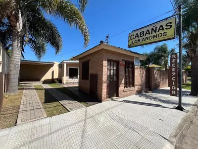 a brick building with a sign in front of it at Chalet Los Aromos in Embalse