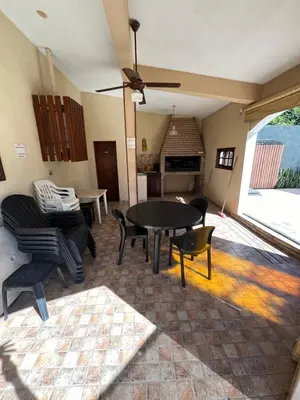 a living room with a table and chairs at Chalet Los Aromos in Embalse