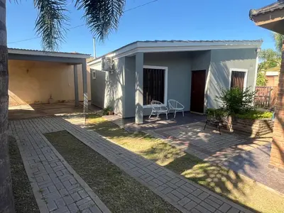 a house with a patio in front of it at Chalet Los Aromos in Embalse