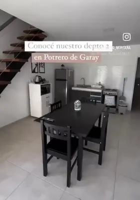 a kitchen with a table and chairs in a room at Complejo Montana in Potrero de Garay