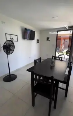 a dining room with a table and chairs and a fan at Complejo Montana in Potrero de Garay