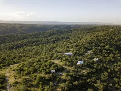 an aerial view of a house in the middle of a forest at Merlín Art Lodge in Atos Pampa