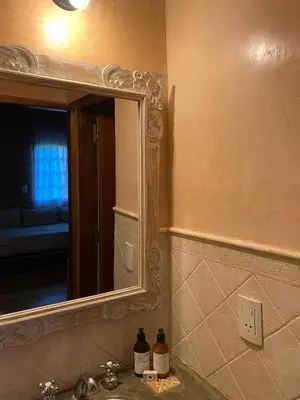 a bathroom with a sink and a mirror at Shamrock House - Casa de Vacaciones en Merlo, San Luis in Merlo