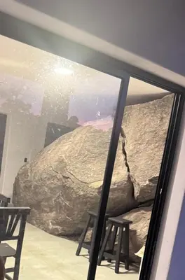 a aquarium with a large rock and two stools at Finca Río Secreto in Taninga