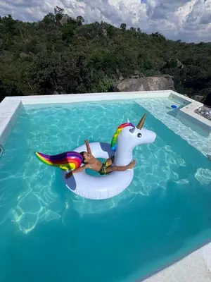 a person in a unicorn float in a swimming pool at Finca Río Secreto in Taninga