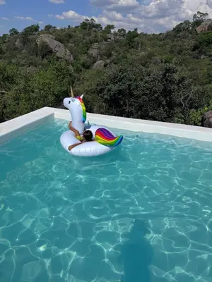 a unicorn float in a pool with a child on it at Finca Río Secreto in Taninga