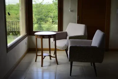 a room with two chairs and a table and a window at Las Calandrias in Los Reartes
