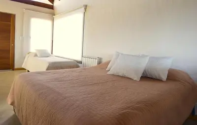 a bedroom with a bed with two pillows on it at Las Calandrias in Los Reartes