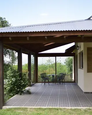 a pavilion with a table and chairs on a patio at Las Calandrias in Los Reartes
