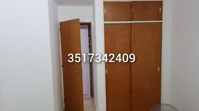 a room with two wooden doors and a hallway at Alojamiento Centro de Carlos Paz in Villa Carlos Paz
