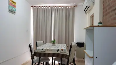 a dining room with a table and chairs and a window at Alojamiento Centro de Carlos Paz in Villa Carlos Paz