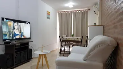 a living room with a white couch and a tv at Alojamiento Centro de Carlos Paz in Villa Carlos Paz